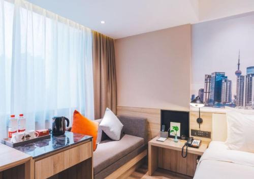 a hotel room with a bed and a window at Atour Hotel New International Expo Center Longyang Road Shanghai in Shanghai