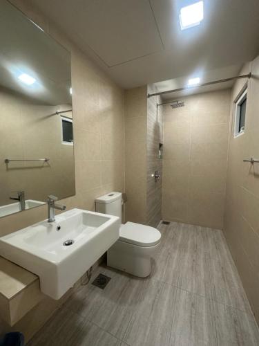 a bathroom with a white sink and a toilet at Windmill Upon Hills & Geo38 Genting in Genting Highlands