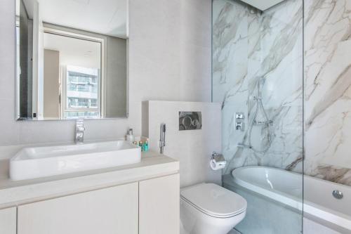 a bathroom with a sink and a toilet and a shower at Frank Porter - Marina Star in Dubai