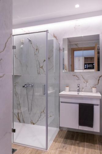 a bathroom with a shower and a sink at IL Mare Plataria in Plataria