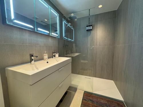 a bathroom with a white sink and a shower at The GG Spot Gledhow Gardens South Kensington Central London by Wild Boutique in London