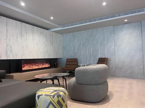 a living room with a couch and a fireplace at Hub Hotel Kaohsiung Yisin Branch in Kaohsiung