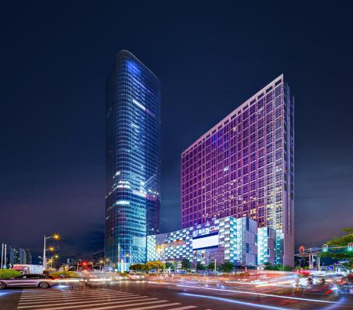 a tall building with lights on it at night at Livetour Hotel HaiZhu Hopson New Plaza Guangzhou in Guangzhou