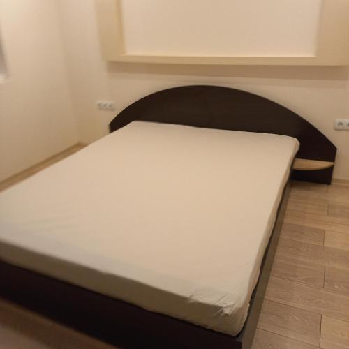 a bed in a room with a white mattress at ПЕТРОВ 1 in Vratsa