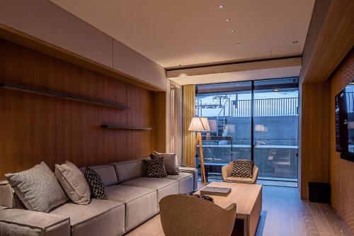 a living room with a couch and a table at MUWA NISEKO in Kutchan