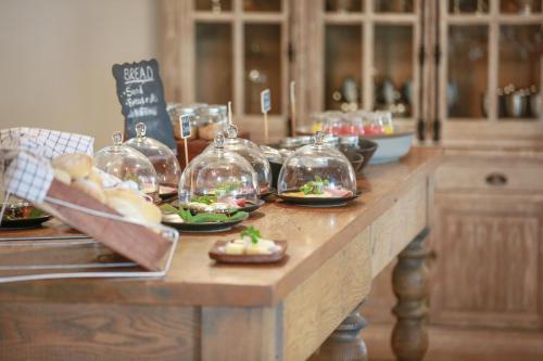 a table with plates of food in glass jars at Otjiwa Safari Lodge in Otjiwarongo