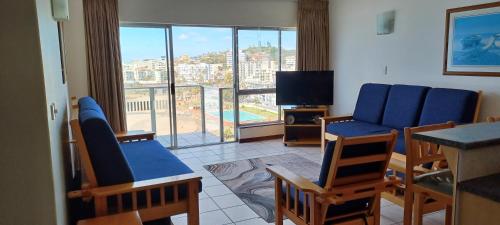 a living room with a couch and chairs and a television at Santana Holiday Resort 1002 in Margate