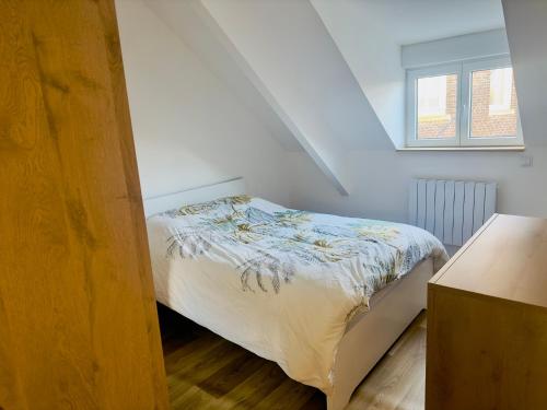 een slaapkamer met een bed en een raam bij Charmant Maison de ville in Le Petit-Quevilly