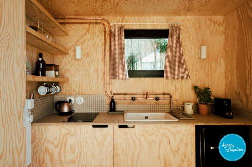 a small kitchen with a sink and a window at Ecolodge Acm in Rovagny