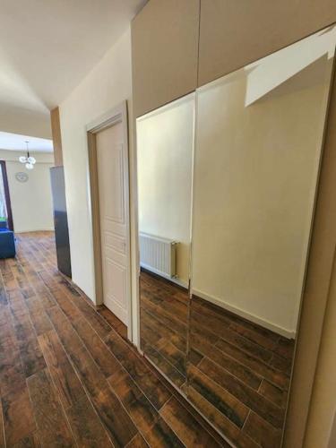 an empty room with a hallway with a hard wood floor at Cozy Apartment 201A • BMIX • in Bakuriani