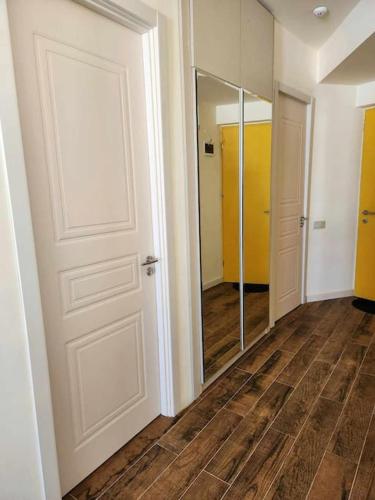 an empty hallway with a door and a mirror at Cozy Apartment 201A • BMIX • in Bakuriani