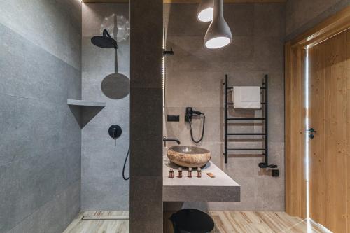 a bathroom with a sink and a shower at Pensjonat Orlik Mountain Resort&SPA in Bukowina Tatrzańska