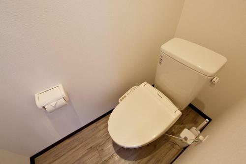 a bathroom with a toilet and two rolls of toilet paper at Clomtown ishigaki in Ishigaki Island