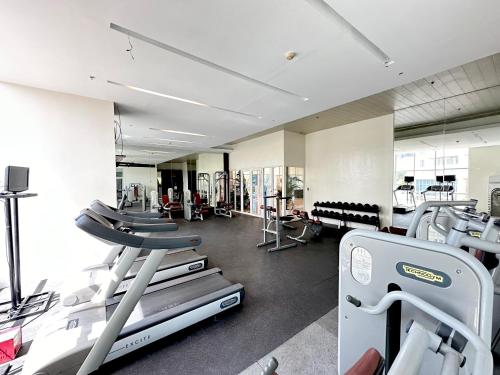 a gym with several treadmills and machines at Sophisticated Oceanview Studio in La Mirada in Mactan