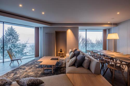 a living room with a couch and a table at MUWA NISEKO in Kutchan