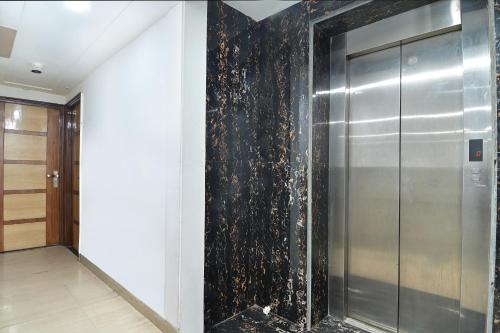a hallway with a elevator in a building at Hotel Glow Inn Paharganj-3 Mins Walk From New Delhi Railway Station in New Delhi