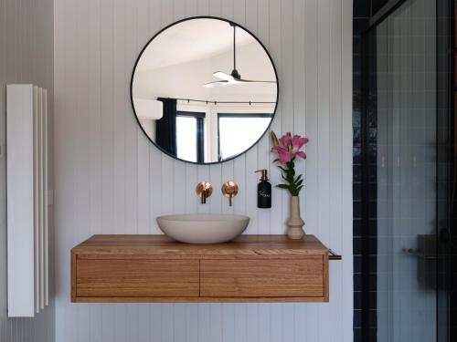 a bathroom with a sink and a mirror at Shawwood Estate in Mudgee