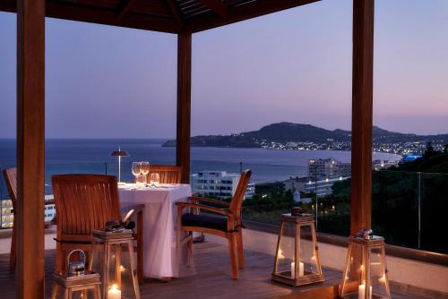 a dining room with a table with a view of the ocean at Esperos Village Blue & Spa - Adults Only in Faliraki