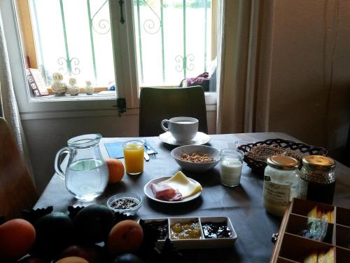 a table with breakfast foods and drinks on it at Maison Bergoun in Borce
