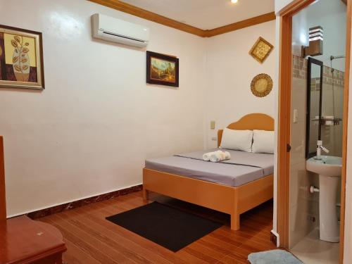 a small bedroom with a bed and a sink at Alona Hidden Dream Resort by SMS Hospitality in Panglao