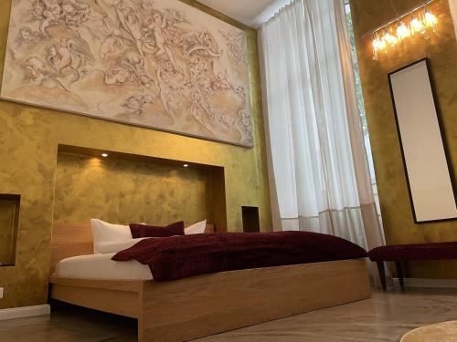 a bedroom with a bed with a painting on the wall at Amical Hotel in Wuppertal