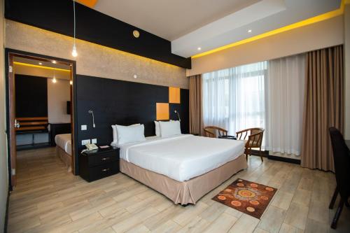 a hotel room with a large bed and a bathroom at Gold Crest Hotel in Mwanza