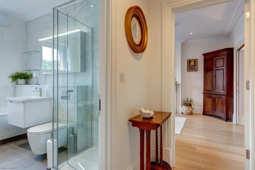 a bathroom with a toilet and a glass shower at University Parks View in Oxford