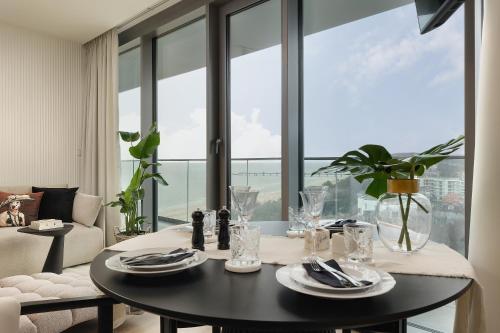 a dining room with a table and a large window at WAVE 10th Floor Baltic View in Międzyzdroje