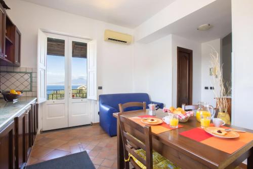 a kitchen and dining room with a table and a dining room at Casale Antonietta in Sorrento