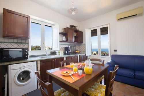 a kitchen with a table and a dining room at Casale Antonietta in Sorrento
