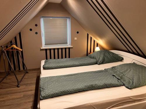 a bedroom with two beds and a window at Ferienwohnung „Zur Eule“ in Hessisch Oldendorf