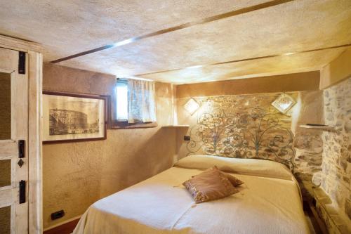 ein Schlafzimmer mit einem Bett mit einem Kissen darauf in der Unterkunft Appartamento dei Raspi d'uva in Apricale