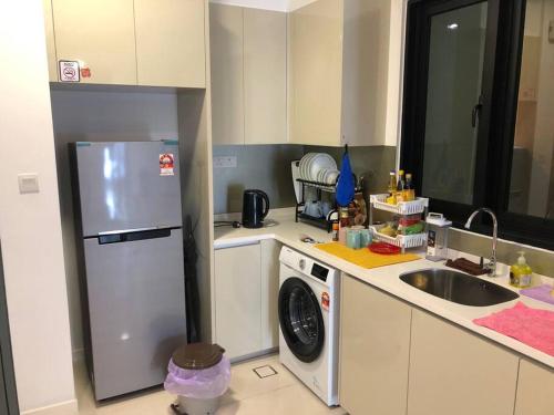 a kitchen with a refrigerator and a washing machine at New Paradigm Residence @1-3/4pax in Johor Bahru