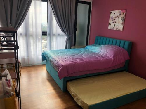 a bedroom with a blue bed and a pink wall at New Paradigm Residence @1-3/4pax in Johor Bahru