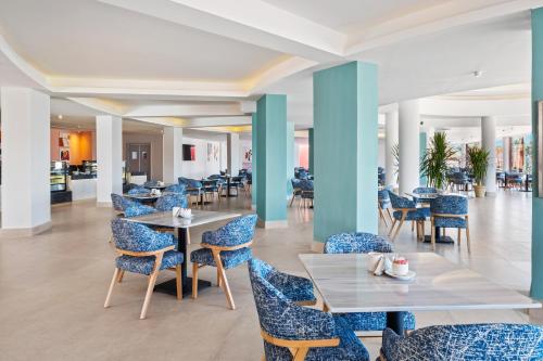a dining room with blue chairs and tables at Pickalbatros Laguna Club Resort Sharm El Sheikh in Sharm El Sheikh