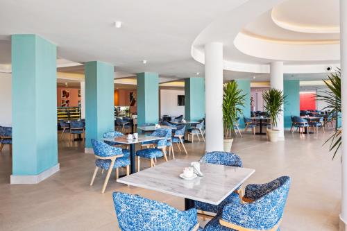 a dining room with blue chairs and tables at Pickalbatros Laguna Club Resort Sharm El Sheikh in Sharm El Sheikh