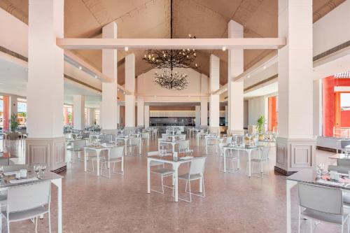 a dining hall with white tables and chairs at Pickalbatros Laguna Club Resort Sharm El Sheikh in Sharm El Sheikh