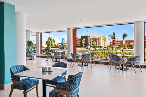 a restaurant with tables and chairs and a view of a city at Pickalbatros Laguna Club Resort Sharm El Sheikh in Sharm El Sheikh