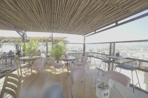 a restaurant with tables and chairs on a roof at Hotel Udai Niwas By The Lake in Udaipur