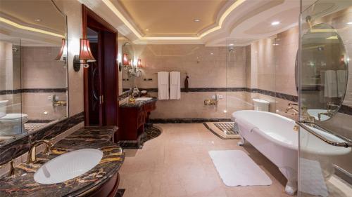 a large bathroom with a tub and a sink at InterContinental Shanghai Ruijin, an IHG Hotel - Downtown Historic Iconic Garden Hotel in Shanghai