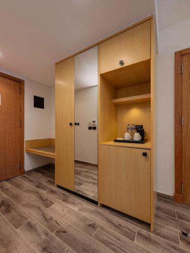 a room with a large wooden closet with a mirror at Creek Hotel and Residences El Gouna in Hurghada