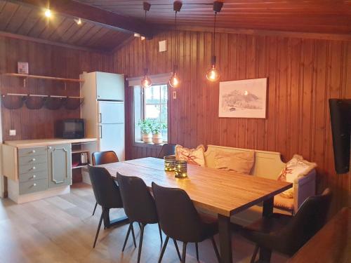 a kitchen and dining room with a wooden table at Cozy cottage in Vemdalen close to the ski slopes in Vemdalen