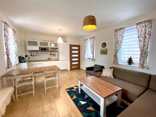 a living room with a couch and a table at Chalet 3 Domky 182 in Belá