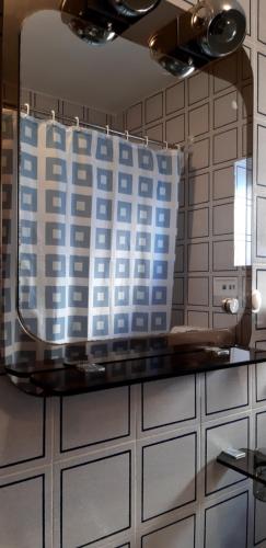 a mirror on a tiled wall in a kitchen at Apartments Belak in Brodarica