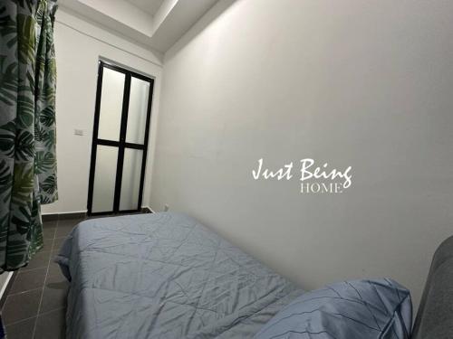 a bedroom with a bed in a room at Just Being Home 5pax 3BR/2BA 2Queen/1Single in Puchong