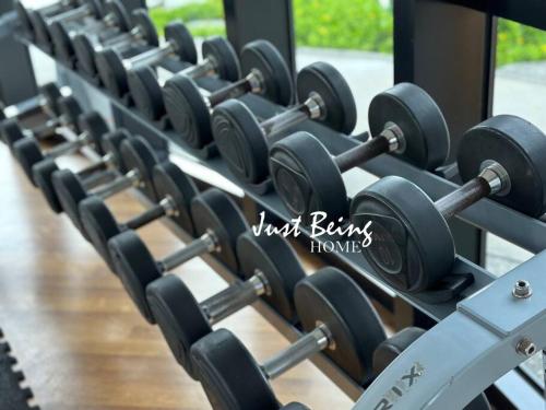 a row of dumbbells in a gym at Just Being Home 5pax 3BR/2BA 2Queen/1Single in Puchong