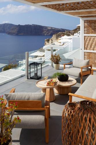 a patio with a view of the water at Filotera Suites in Oia