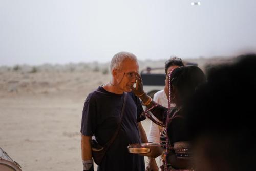 a man talking on a cell phone next to a woman at Prince Desert Camp in Sām