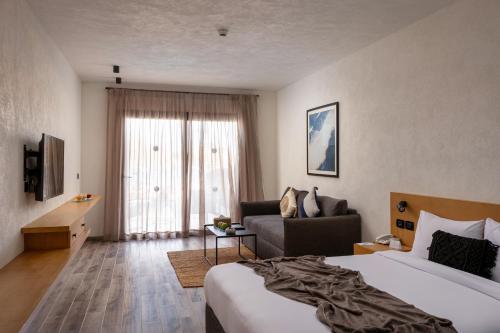 a hotel room with a bed and a couch at Creek Hotel and Residences El Gouna in Hurghada