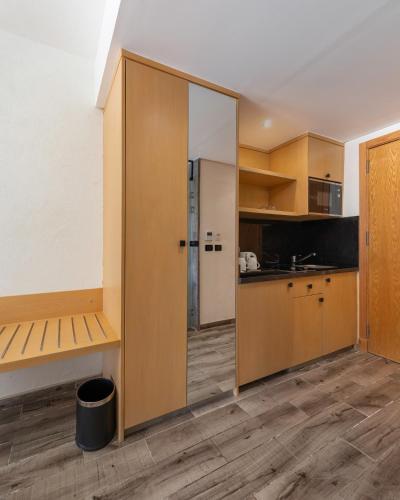 a kitchen with wooden cabinets and a large sliding glass door at Creek Hotel and Residences El Gouna in Hurghada